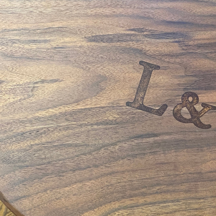 photo of a walnut charcuterie with the letters L and N on the surface filled with epoxy and resin copper colour