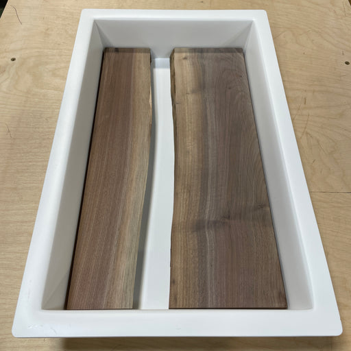 10 x 18 HDPE epoxy mold with two live edge wood pieces set up for a resin river board project