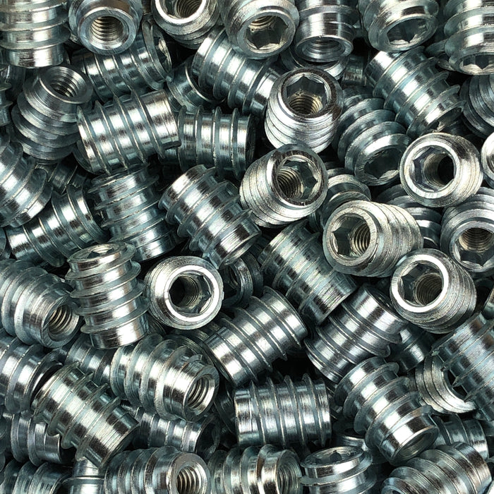 Close-up of a pile of metal screws with threaded design