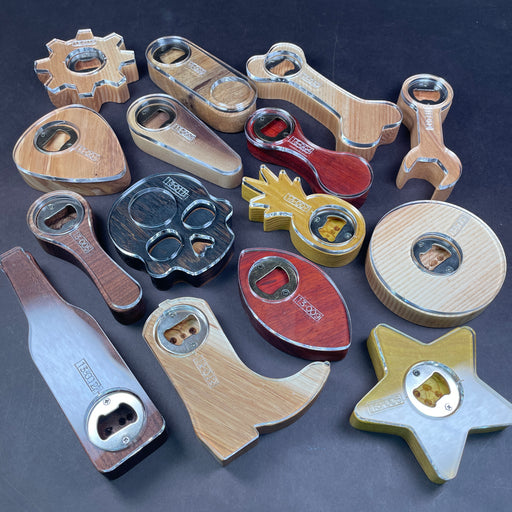 A preview photo showing 15 different styles of bottle openers on wood. Unique species and different themes will appeal to any beer drinker