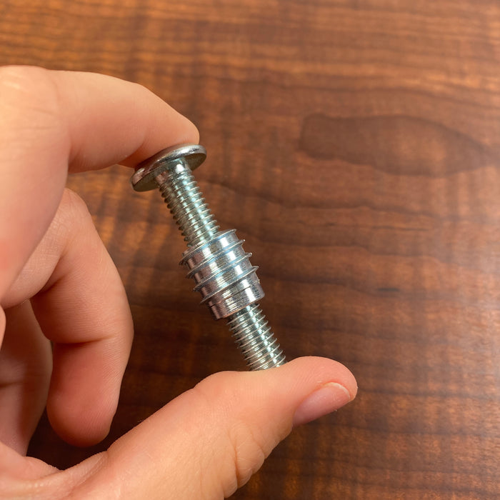 glat head screw with a threaded insert twisted almost half way up the threads