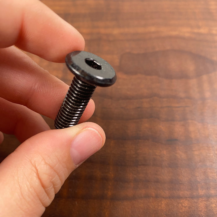 black threaded insert that has a thicker diameter of 8 millimeters 