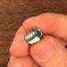 two fingers showing how small the threaded insert is for scale. small but powerful