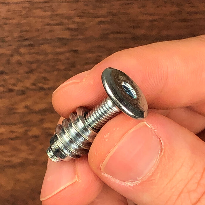 threaded insert on the otter part of a screw being held in a hand to show you how it sleeves over and can be used at different legths
