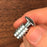 small mushroom head bolt with threaded insert attached and screwed on to the bottom